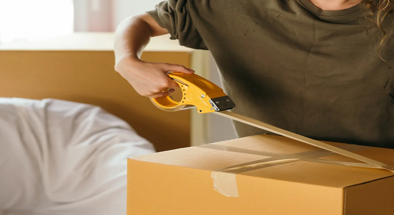 Sealing a moving box with packing tape